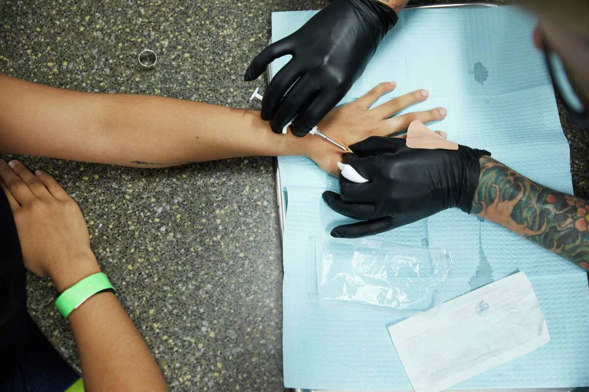 A TV reporter gets a microchip embedded under her skin during a "chip party" at Three Market Square in River Falls, Wis., on Tuesday. MUST CREDIT: Photo for The Washington Post by Tim Gruber