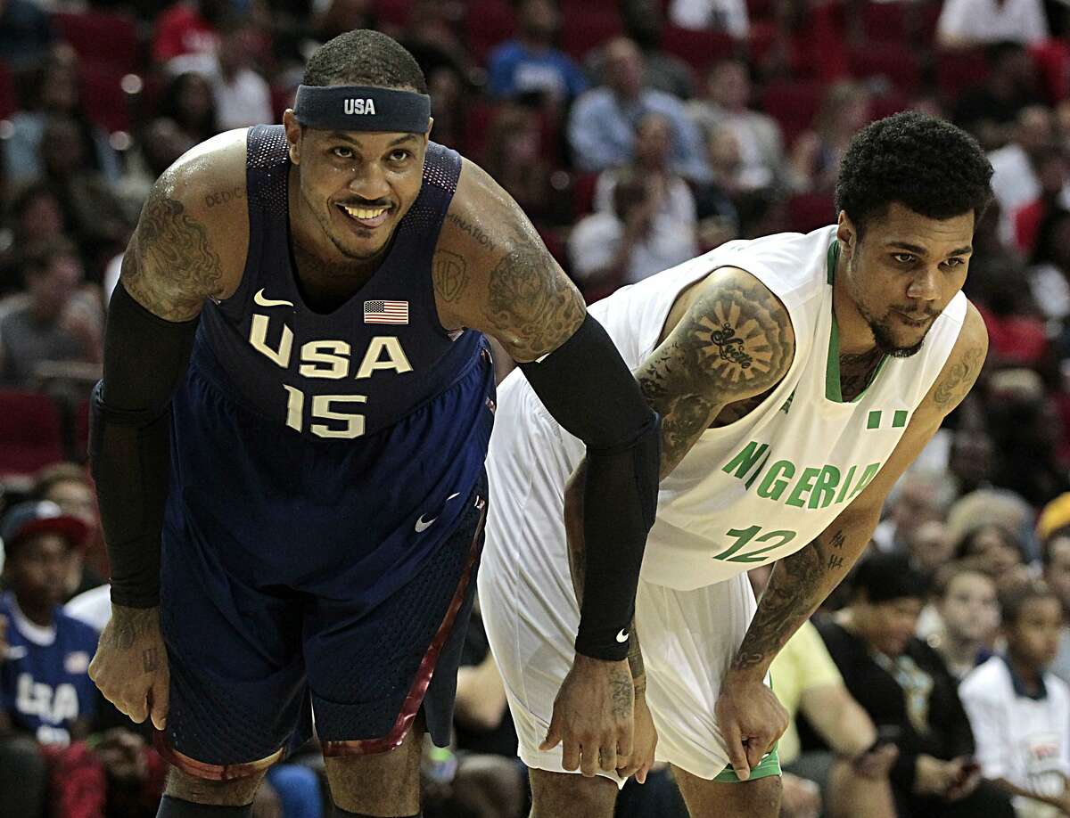 USA Basketball Men's National Team's Carmelo Anthony left, and the Nigerian National Team's Michael Gbinije right, during the second half of the USA-Nigeria exhibition game at the Toyota Center Aug. 1, 2016, in Houston. ( James Nielsen / Houston Chronicle )
