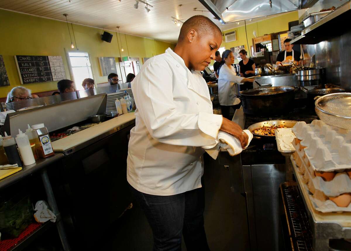 Tanya Holland, owner of Brown Sugar Kitchen, a popular eatery on Mandela Parkway helps prepare brunch for a standing room only crowd Sunday October 12, 2014. Twenty-five years after the Loma Prieta earthquake toppled the Cypress freeway and killed over 40 people in West Oakland, the community is seeing new life and energy.