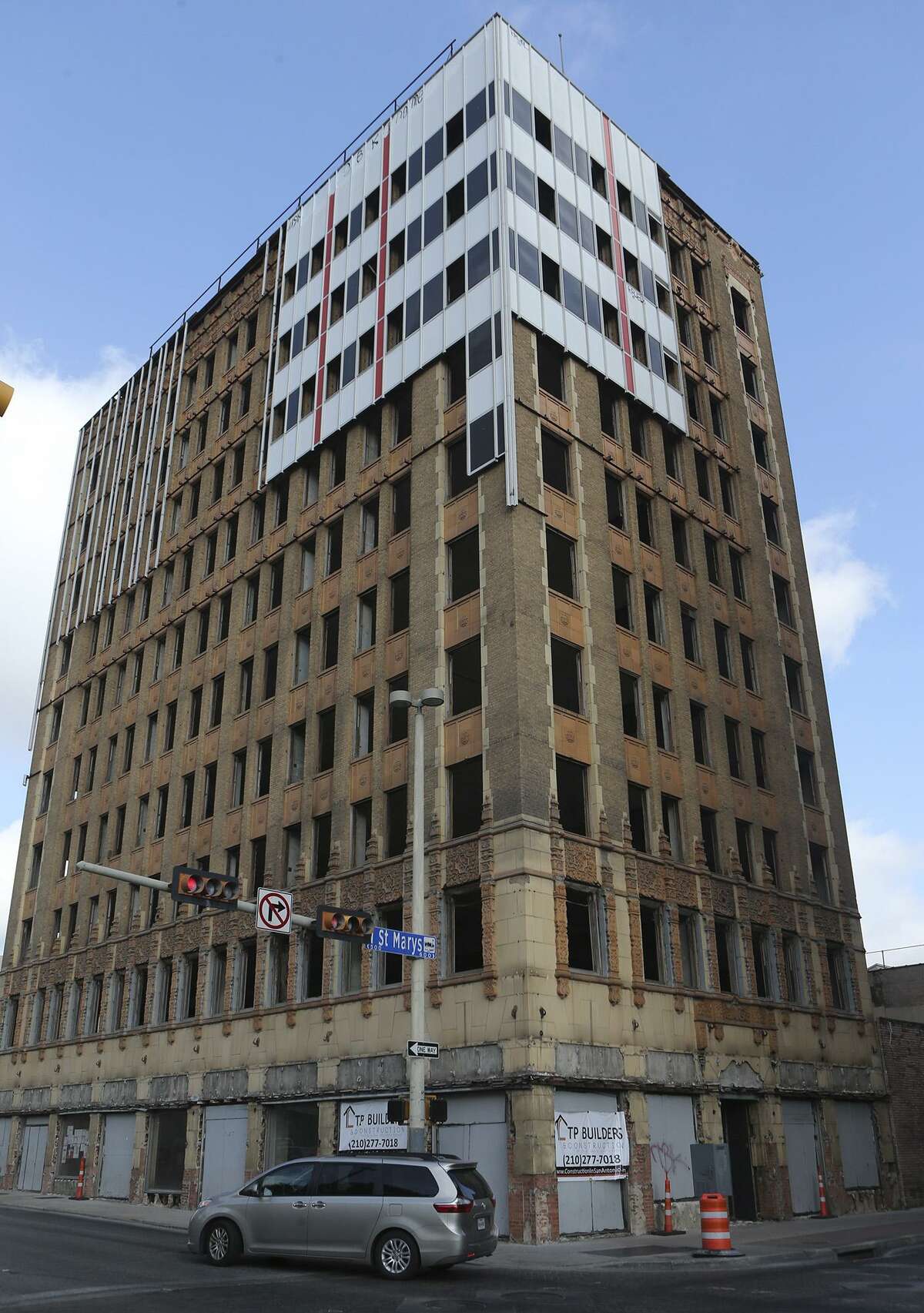 Workers have removed most of the 1960s aluminum cladding from the downtown Hedrick Building to reveal its 1928 limestone and terra cotta facade underneath.