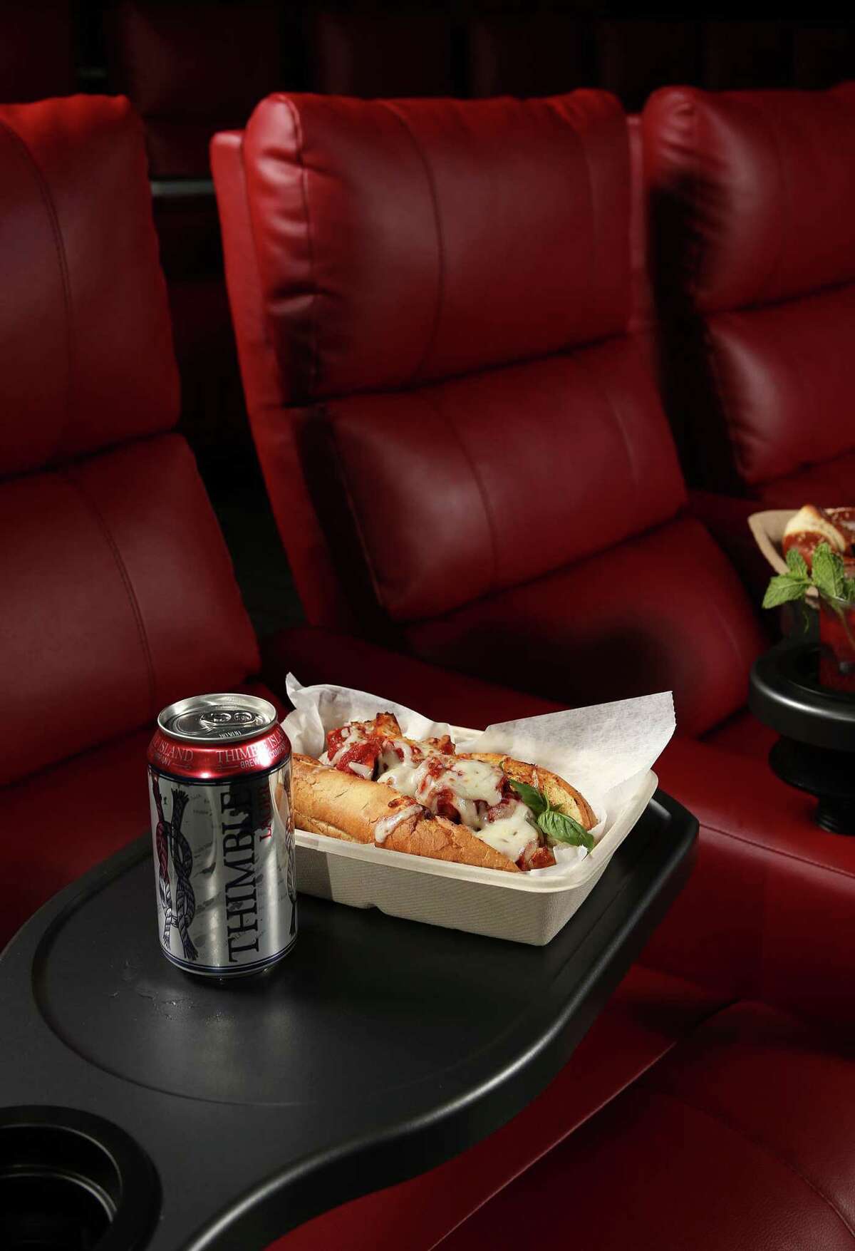 Trays for hot food and plush seats make moviegoers feel at home.