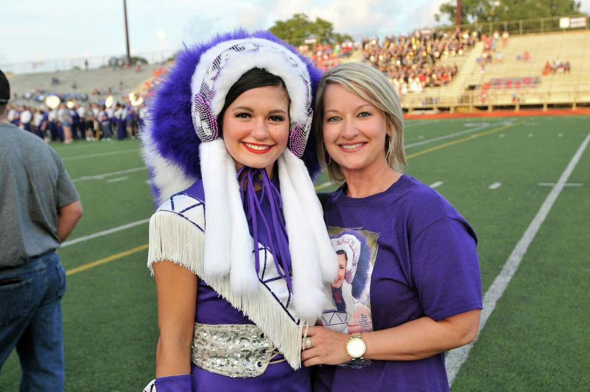 Members of the Port Neches-Groves Indians Marching Band, Indianettes, Twirlers and other student groups stand with their parents during Parents' Night ceremonies before the start of Wednesday's game with the Lumberton Raiders at Indian Stadium in Port Neches. (Mike Tobias/The Enterprise)
