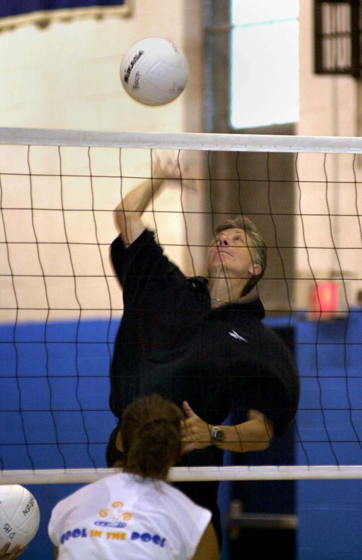 Darien High School girls volleyball coach oach Laurie LaRusso hits the ball to her team during practice drills in 2003