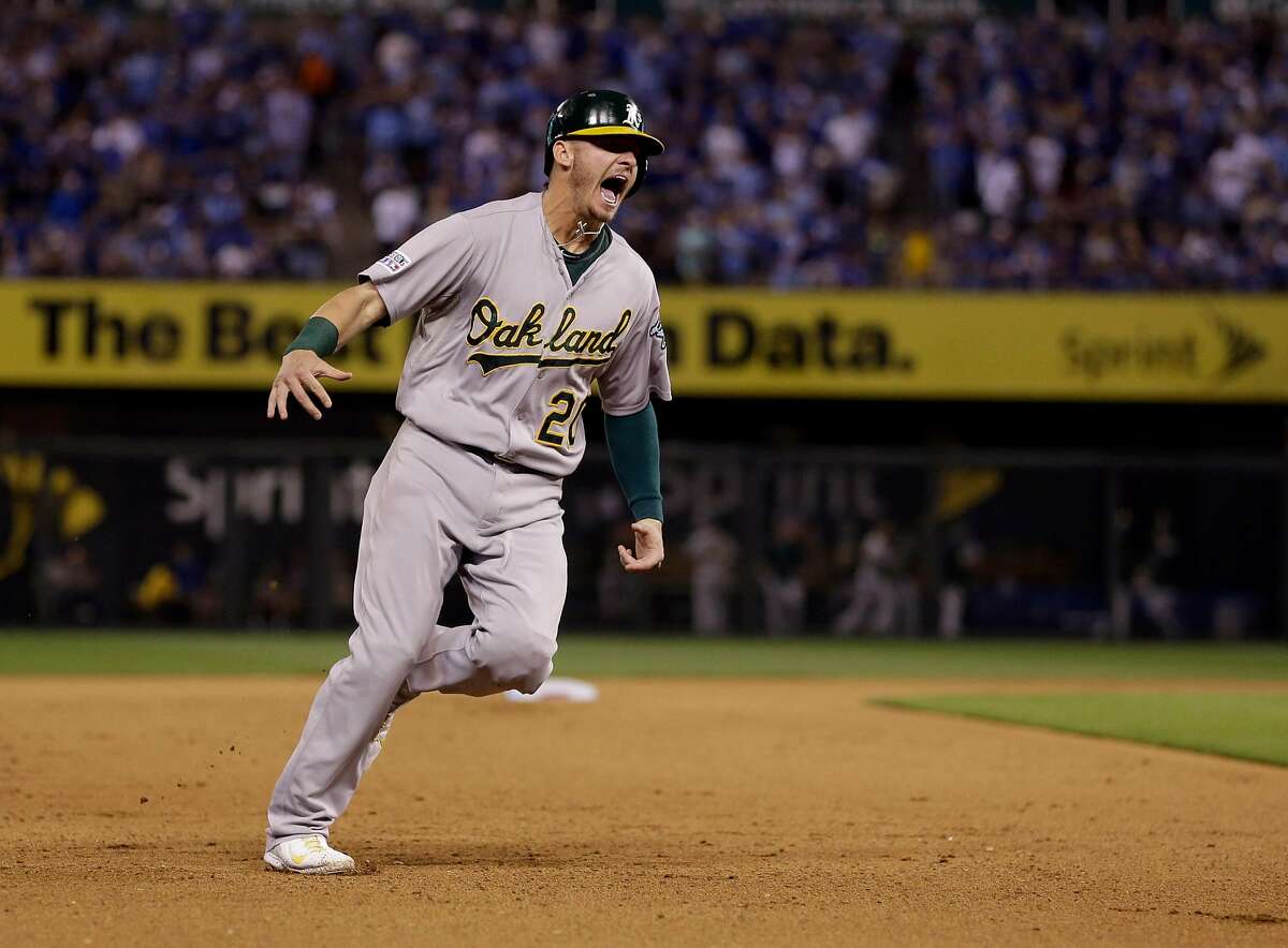 Oakland Athletics' Josh Donaldson celebrates as he rounds the bases on a three-run home run by teammate Brandon Moss during the sixth inning of the AL wild-card playoff baseball game against the Kansas City Royals Tuesday, Sept. 30, 2014, in Kansas City, Mo. The home run was Moss' second of the game. (AP Photo/Jeff Roberson)