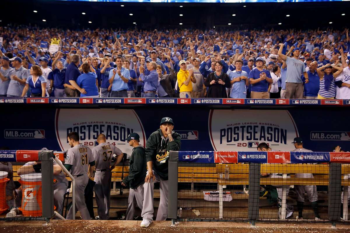 Members of the Oakland Athletics sit in the dugout after being defeated 9-8 by the Kansas City Royals in the AL wild-card playoff baseball game Tuesday, Sept. 30, 2014, in Kansas City, Mo. (AP Photo/Jeff Roberson)