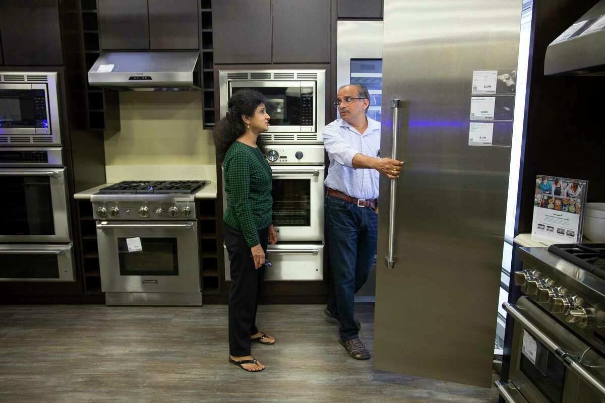 Gana and Aruna Mahendravada shop for new kitchen appliances at the Best Buy store on Richmond Avenue near 610, Thursday, Sept. 21, 2017. The Mahendravada's home in Bellaire flooded with ten inches of water last month. The home was raised after Tropical Storm Allison, and the family had never seen the house flood in the ten years they have lived there. (Mark Mulligan / Houston Chronicle)