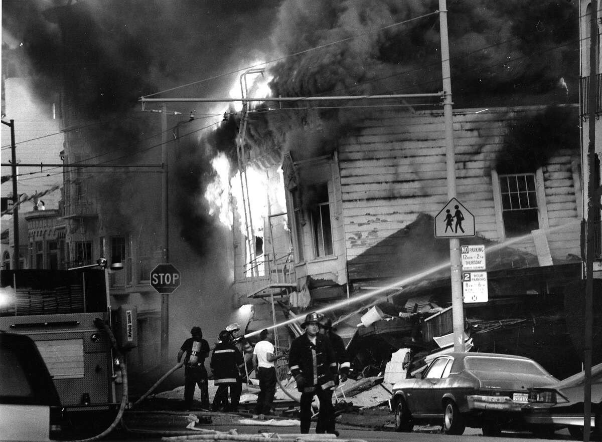 Firefighters trying to save houses in the Marina district of San Francisco after the quake on October 17, 1989.