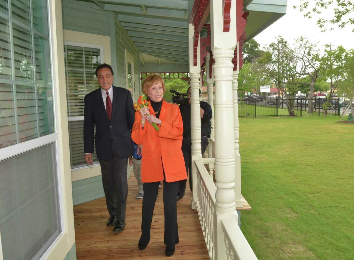 Former San Antonio mayor Henry Cisneros and Carol Burnett tour the renovated house and wraparound porch on West Commerce. She lived in the original with her beloved grandmother until age 7. She was happy to see it being put to good use as a learning center for needy neighborhood kids and their parents.