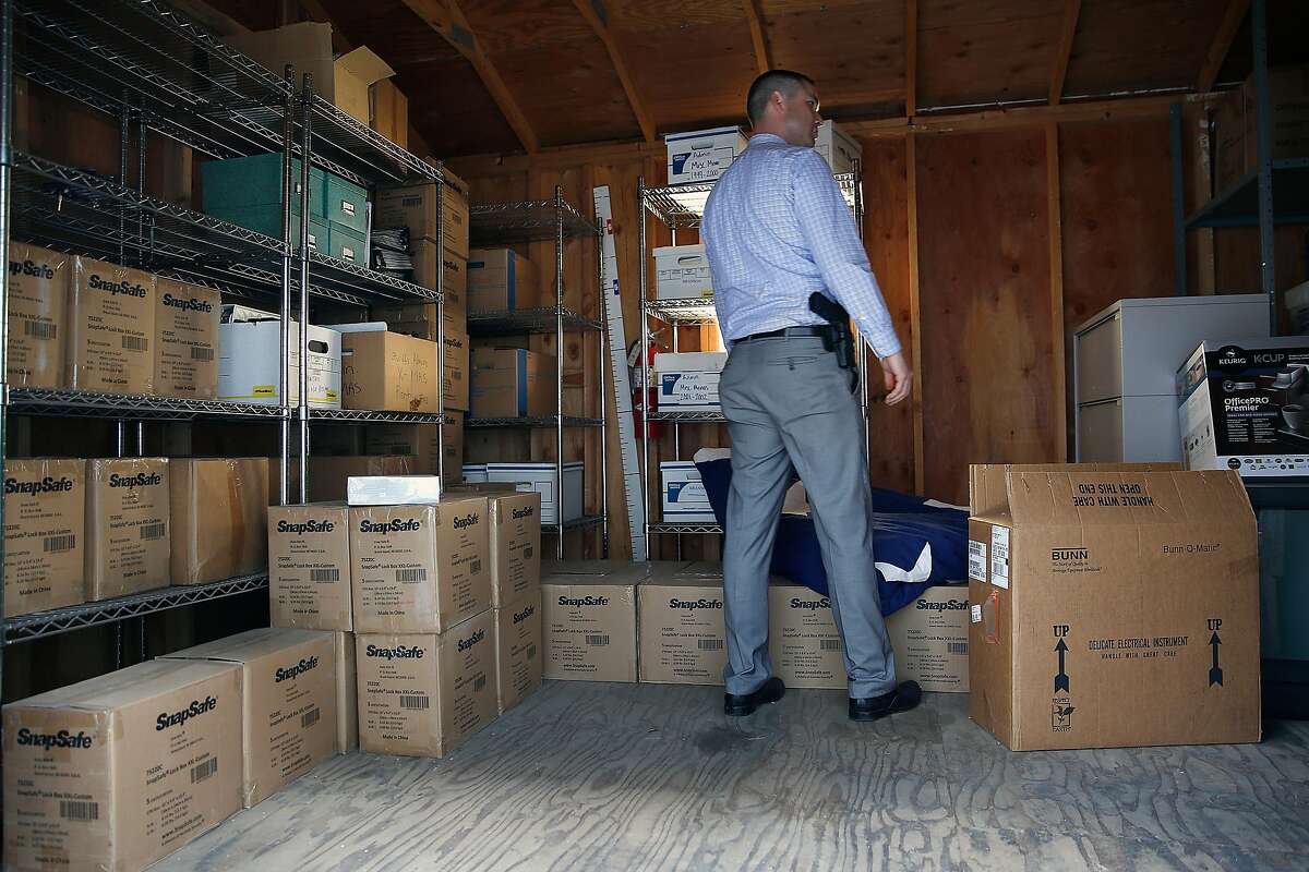 Sergeant Richard Glennon shows where some of the 750 gun vaults are stored at the Santa Clara county sheriffs department on Friday, September 22, 2017, in San Jose, Calif. The Santa Clara County Sheriff took a proactive approach in October 2016 and purchased 750 portable gun vaults for her deputies' personal vehicles and staff cars where no guns have been stolen since from a Santa Clara County deputy.