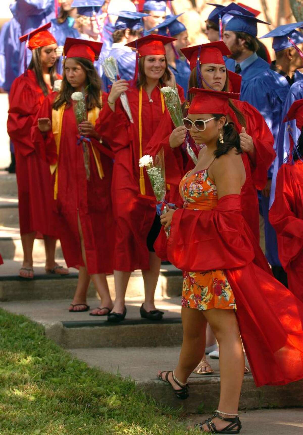 Because of the high temperatures, graduate Carly Cammarano keeps her graduation gown off to keep cool, before the start of Foran High School's Graduation Exercises in Milford, Conn. on Wednesday June 23, 2010.