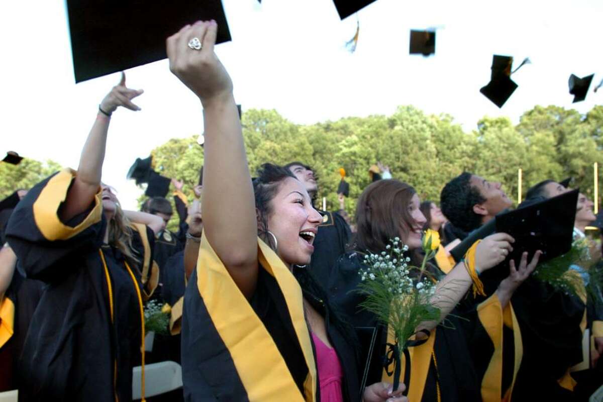 Graduate Yanina Haines tosses her cap into the air with her classmates at the end of the 2010 Jonathan Law High School commencement ceremony Wednesday June 23, 2010 at the school in Milford.