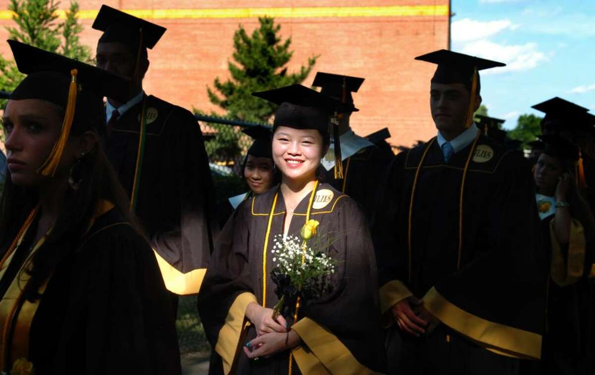 Valedictorian Bing Zheng marches down to the football field with her fellow classmates for the 2010 Jonathan Law High School commencement ceremony Wednesday June 23, 2010 at the school in Milford.