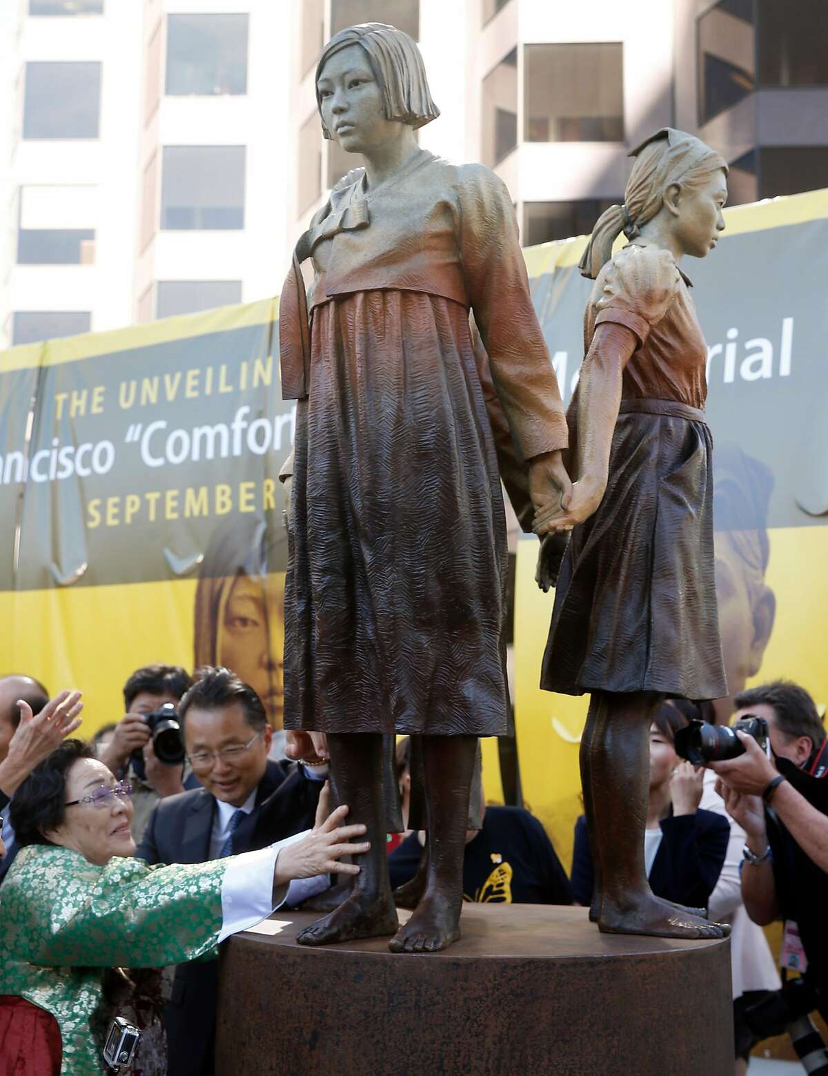 Former "comfort woman" Grandma Yong-soo Lee reaches out to touch the Comfort Women Memorial statue after it's unveiled at St. Mary's Square park in Chinatown in San Francisco, Calif. on Friday, Sept. 22, 2017. During World War II, thousands of women were captured and used as sex slaves by the Japanese military.