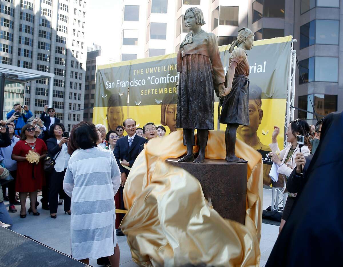 Dignitaries unveil the Comfort Women Memorial statue to honor comfort women from World War II at St. Mary's Square park in Chinatown in San Francisco, Calif. on Friday, Sept. 22, 2017. During the war, thousands of women were captured and used as sex slaves by the Japanese military.