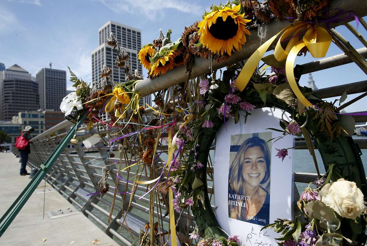In this Friday, July 17, 2015 photo, flowers and a portrait of Kate Steinle remain at a memorial site on Pier 14 in San Francisco, Calif., for Steinle who was gunned down by Juan Francisco Lopez-Sanchez, a Mexican citizen who authorities contend was in the country illegally. Lopez Sanchez, who was deported five times, admits fatally shooting Steinle while she walked with her father on the San Francisco pier crowded with tourists. He has said the shooting was accidental and has pleaded not guilty to second-degree murder. (Paul Chinn /San Francisco Chronicle via AP)
