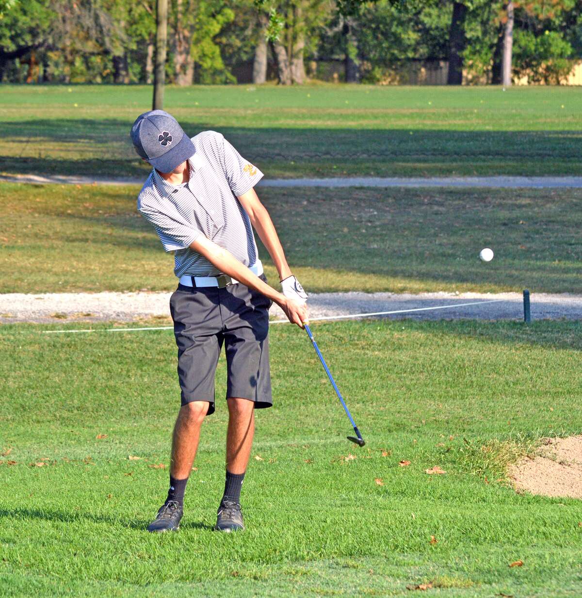 Edwardsville junior Parker Griffiths, playing for EHS Grey, hits a chip shot on hole No. 7.
