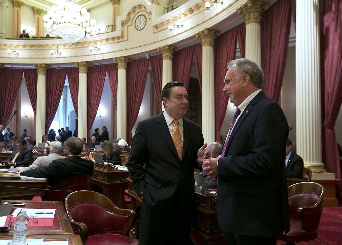 State Sen. Joel Anderson, R-Alpine, left, talks with fellow GOP Sen. Mike Morrell, of Rancho Cucamonga, during the final day of this year's legislative session at the Capitol, Friday, Sept. 15, 2017, in Sacramento, Calif. (AP Photo/Rich Pedroncelli)
