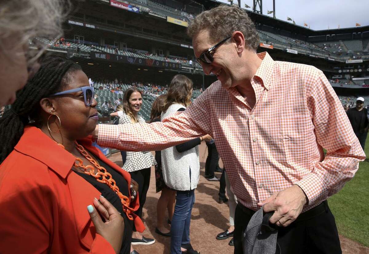Hamilton Families CEO Tomiquia Moss and Giants CEO Larry Baer chat at a ceremony at AT&T Park when the Giants made a pitch for the homeless.