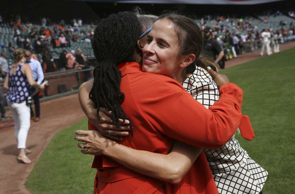 Tomiquia Moss of Hamilton Families embraces Kristen Berlacher of Airbnb, which has partnered with the Giants to give $300,000 to help Moss’ program.