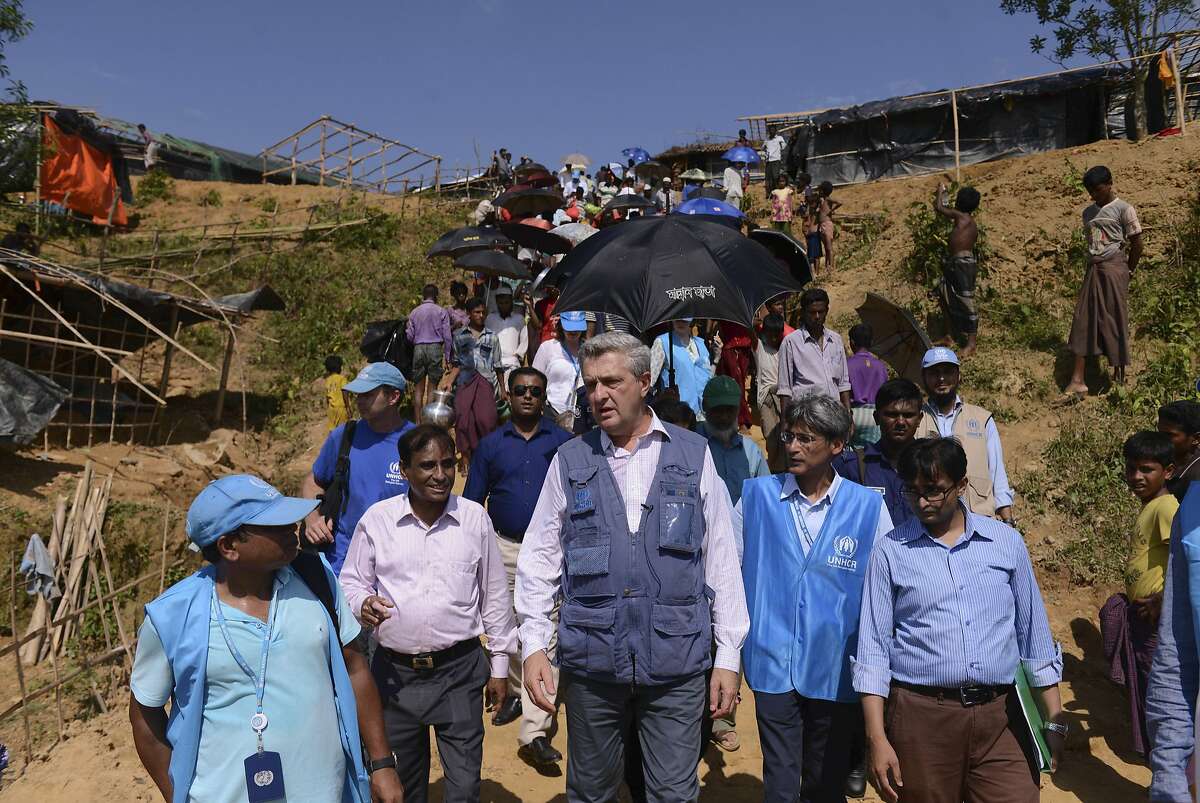 United Nations High Commissioner for Refugees Filippo Grandi, center, visits newly arrived Rohingya Muslims at Kutupalong refugee camp, Bangladesh, Saturday, Sept. 23, 2017. More than 400,000 ethnic Rohingya Muslims have poured into Bangladesh since the latest wave of violence exploded in their nearby home of Myanmar last month. The crisis has drawn global condemnation, with the United Nations and human rights groups calling on Myanmar to end what they describe as a systematic campaign of ethnic cleansing. (AP Photo/Ziaul Haque Oisharjh)