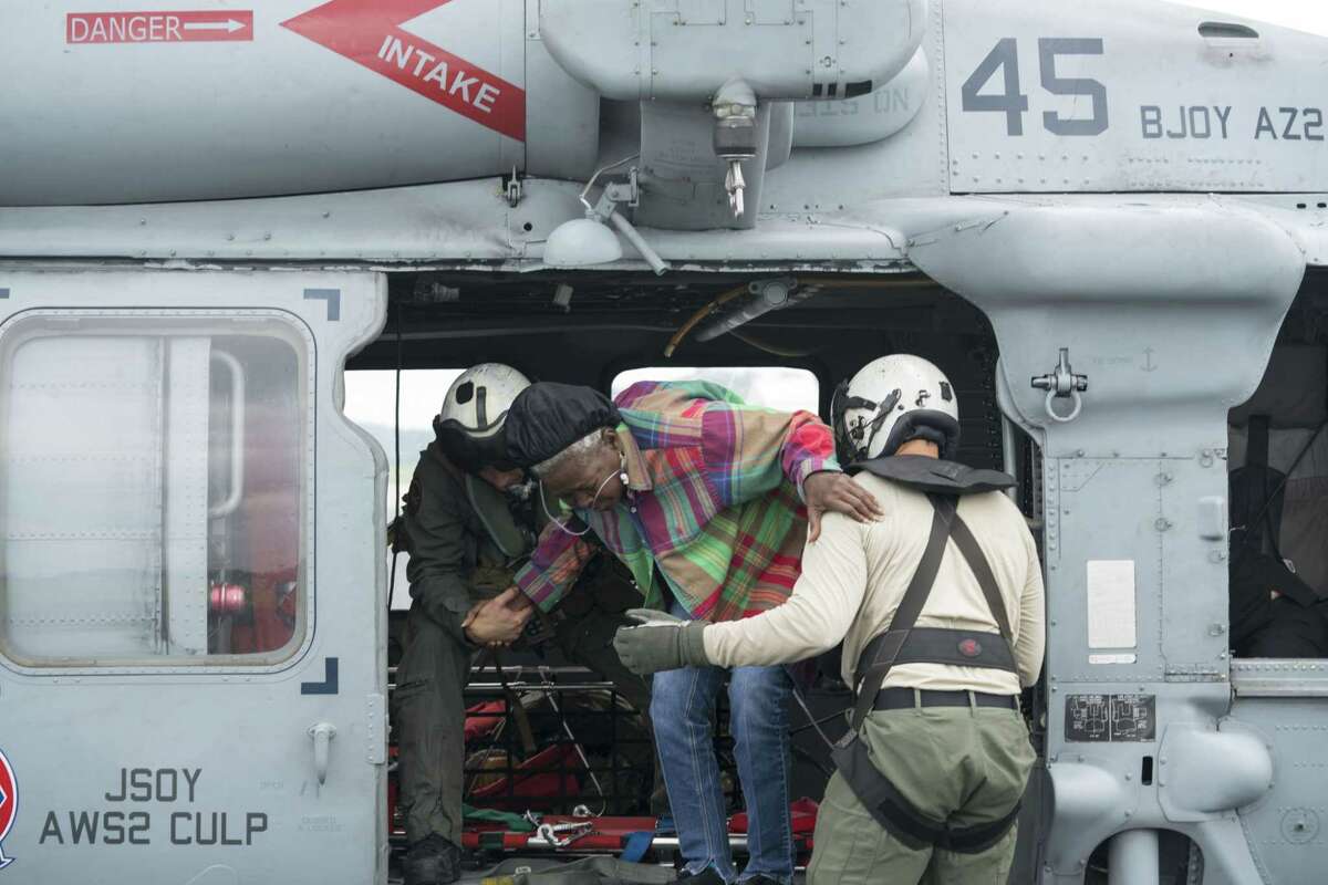 U.S. Navy crewmen assist with a medical evacuation during Hurricane Harvey relief efforts in Jasper, Texas.