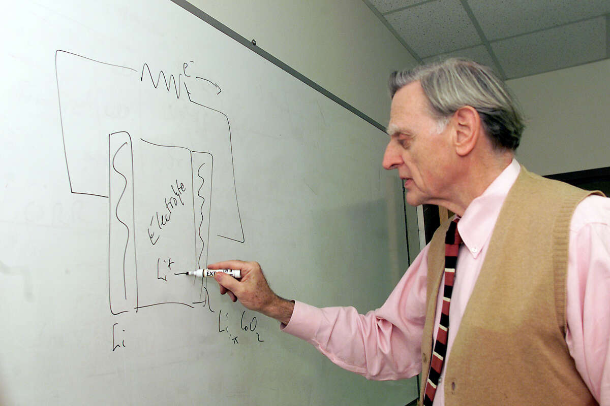 John B. Goodenough draws a diagram of a battery on the board in his office at the University of Texas at Austin.