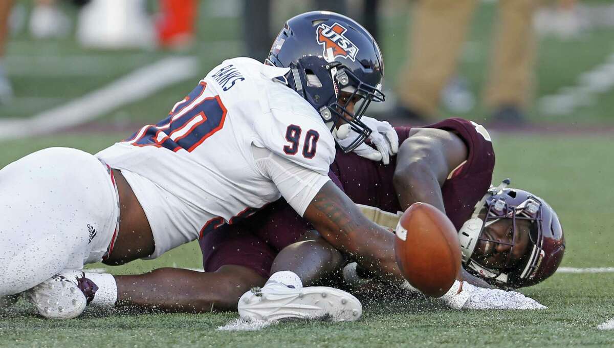 Texas State Bobcats quarterback Damian Williams (12) fumbles the ball after being hit by UTSA Roadrunners defensive end Eric Banks (90) during first half action on Sept. 23, 2017 at Bobcat Stadium in San Marcos.
