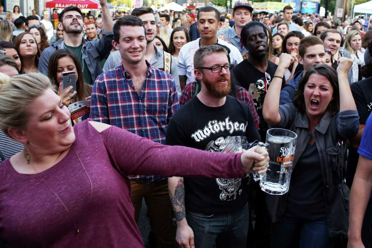 People cheer as contestants try to hold up a full stein for as long as they can during the annual Fremont Oktoberfest, Saturday, Sept 23, 2017.