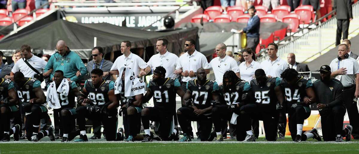 LONDON, ENGLAND - SEPTEMBER 24: Jacksonville Jaguar players show their protest during the National Anthem during the NFL International Series match between Baltimore Ravens and Jacksonville Jaguars at Wembley Stadium on September 24, 2017 in London, England.