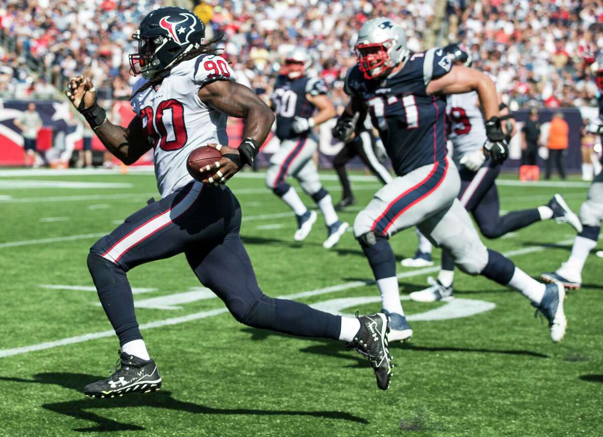 Houston Texans outside linebacker Jadeveon Clowney (90) runs past New England Patriots offensive tackle Nate Solder (77) as he returns a Tom Brady fumble 22 yard for a touchdown during the second quarter of an NFL football game at Gillette Stadium on Sunday, Sept. 24, 2017, in Foxbourough, Mass.