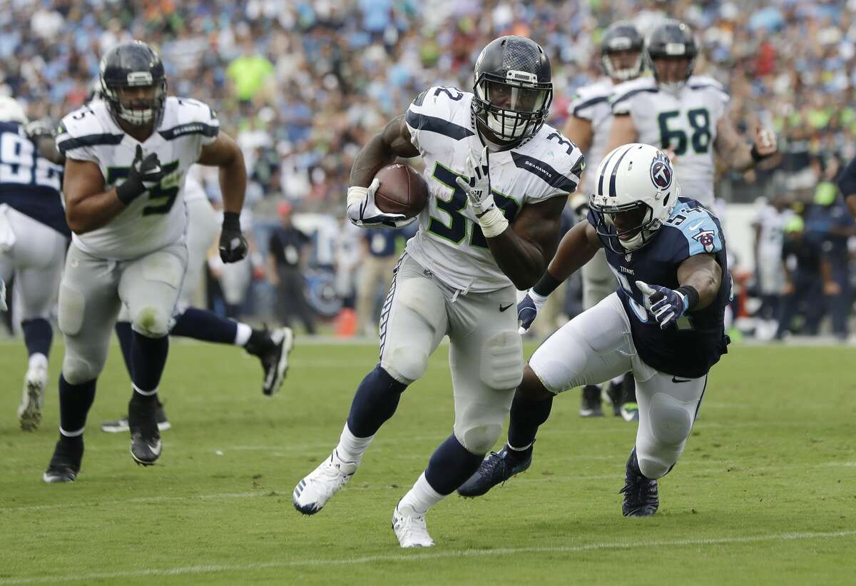 Seattle Seahawks running back Chris Carson (32) gets past Tennessee Titans inside linebacker Avery Williamson (54) as Carson scores a touchdown on a 10-yard run in the second half of an NFL football game Sunday, Sept. 24, 2017, in Nashville, Tenn. (AP Photo/James Kenney)