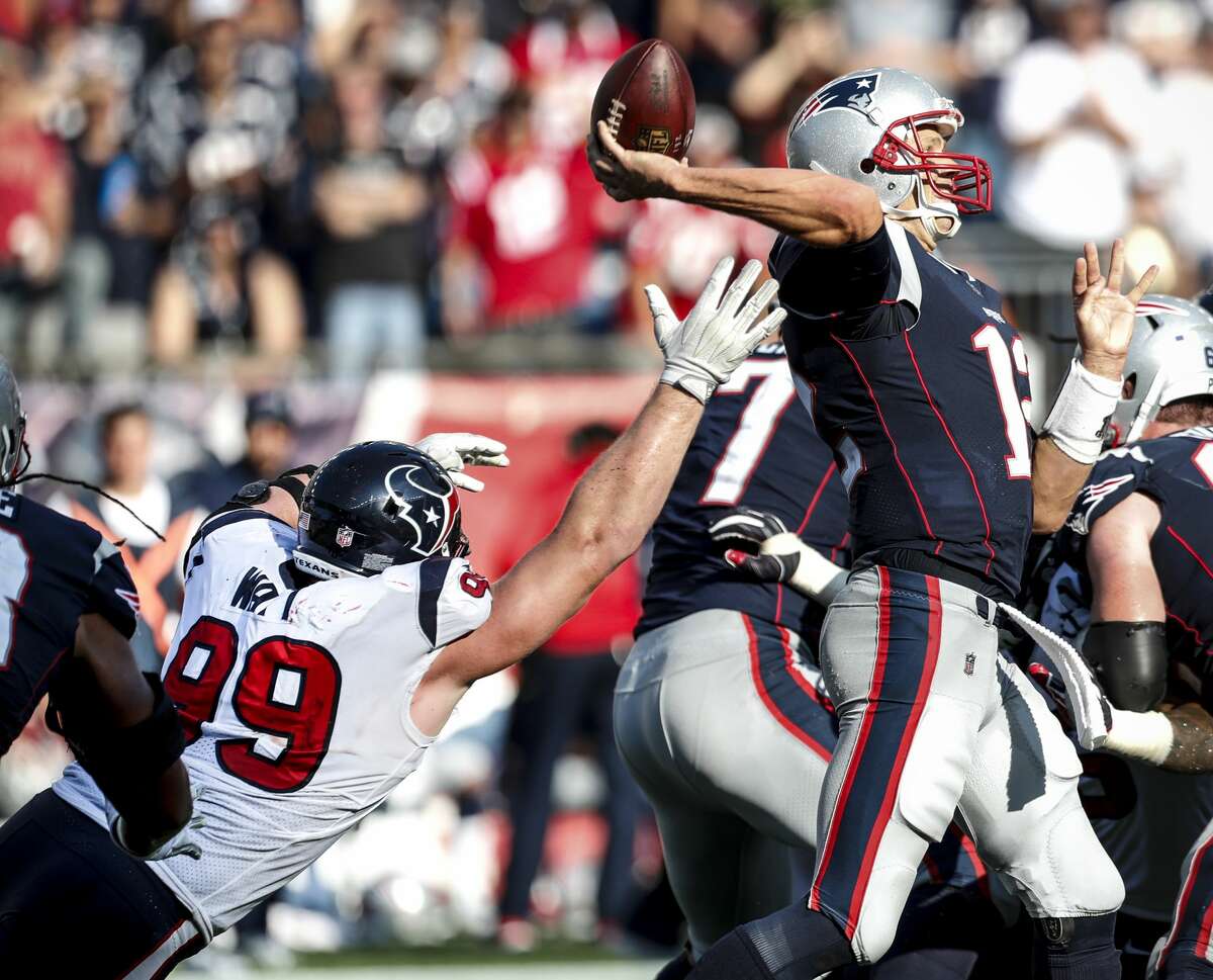 Houston Texans defensive end J.J. Watt (99) reaches out in vain to stop New England Patriots quarterback Tom Brady (12), as he throws for a 27-yard completion to Danny Amendola and a first down during the fourth quarter of an NFL football game at Gillette Stadium on Sunday, Sept. 24, 2017, in Foxbourough, Mass. ( Brett Coomer / Houston Chronicle )