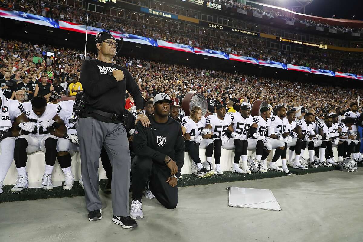 Some members of the Oakland Raiders kneel during the playing of the National Anthem before an NFL football game against the Washington Redskins in Landover, Md., Sunday, Sept. 24, 2017. (AP Photo/Alex Brandon)