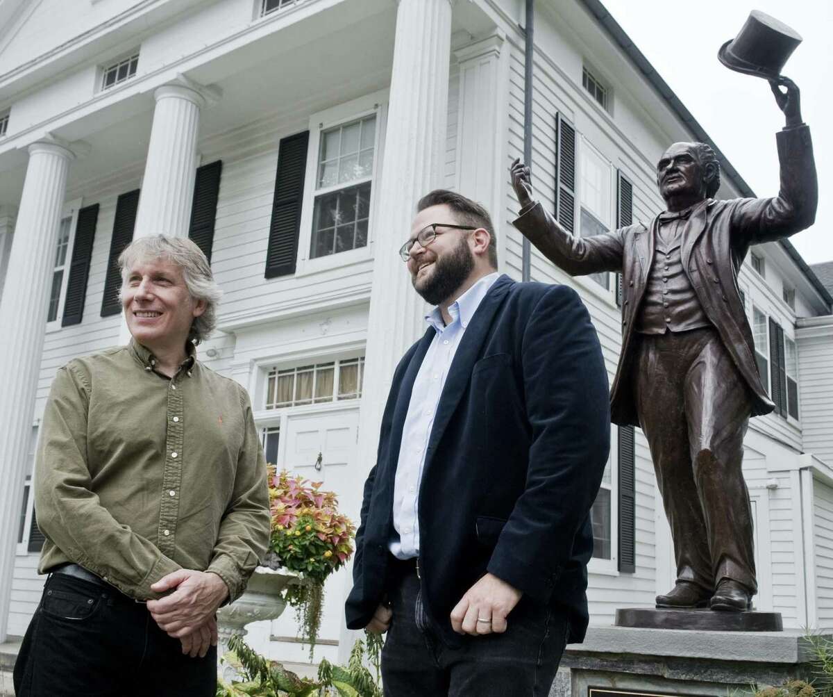Sculptor Dave Gesualdi, of Bethel, and Connecticut filmmaker Corey Boutilier, of Westport, with the P.T. Barnum statue, in front of the Bethel Library last week.