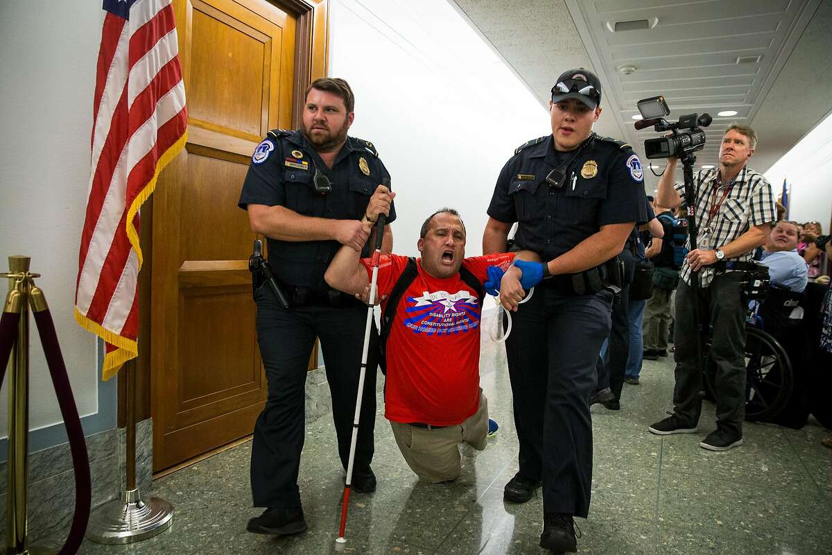 A protester who supports the Affordable Care Act is removed by U.S. Capitol Police during a Senate hearing on a 2017 proposal to repeal and replace the Affordable Care Act. The Department of Justice has just filed a brief in support of repealing the entirety of the Affordable Care Act in a case pending before the 5th Circuit Court in New Orleans.