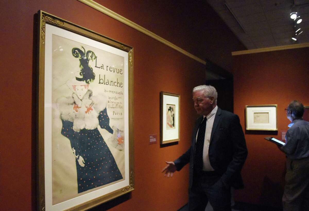 Bruce Museum Executive Director Peter Sutton shows the lithograph "La Revue Blanche" at the new Henri de Toulouse-Lautrec exhibit at the Bruce Museum in Greenwich, Conn. Monday, Sept. 25, 2017. The show "examines the relationship between portraiture, caricature, and rise of the cult of celebrity in the late 19th century, while focusing on the artist?’s portraits of entertainers who became icons of the Parisian nightlife." The exhibit features 100 drawings, prints, and posters and will be up through Jan. 7, 2018.