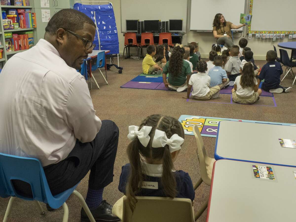 Midland ISD Superintendent Orlando Riddick sits with a South Elementary School pre-k student who was a little shy about joining her classmates on the first day of school.