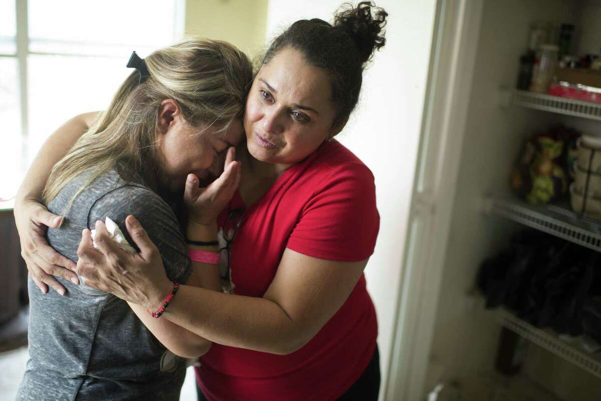 A neighbor consoles Ruby Rodriguez in her water-damaged house in Houston on Sept. 3. Rodriguez fled the rapidly flooding house clutching a briefcase containing all the paperwork for her daughter's DACA application. MUST CREDIT: Photo by Michael Robinson Chavez for The Washington Post.