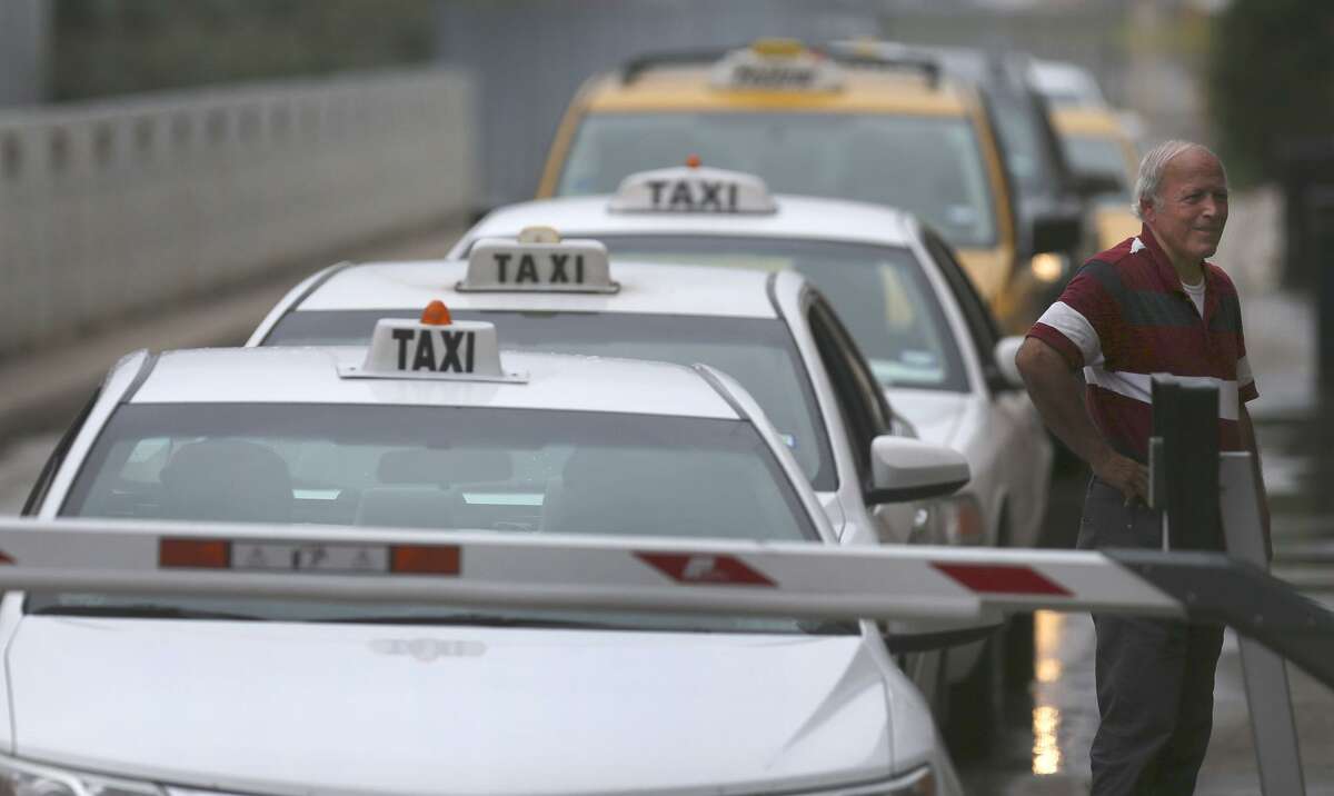 Taxi cabs line up Tuesday September 26, 2017 at the San Antonio International Airport. San Antonio's City Council public safety committee will consider Tuesday a proposal that the city remove all limits on cab permits.
