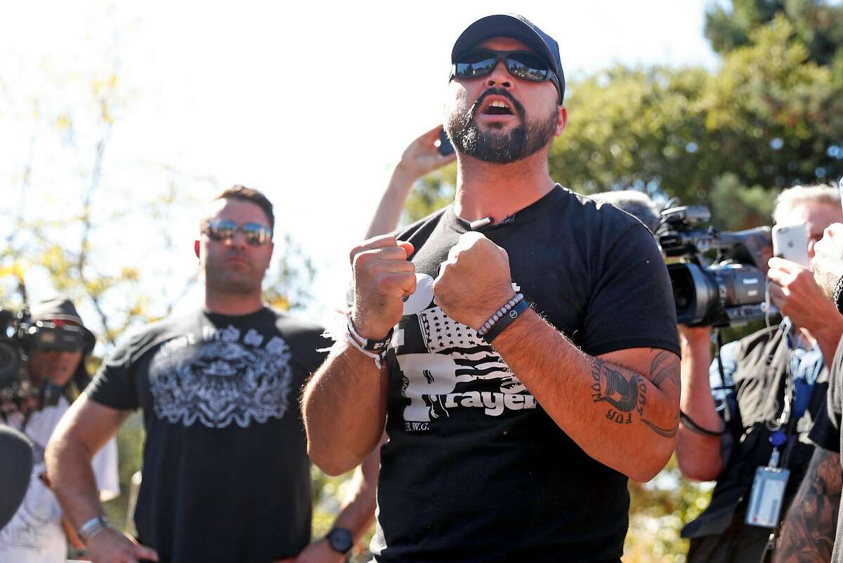 Patriot Prayer organizer Joey Gibson (right) and right wing activist Kyle Chapman on stage during a gathering at People's Park in Berkeley, Calif., on Tuesday, September 26, 2017.