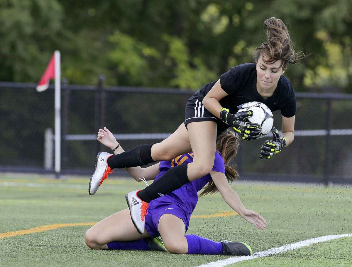 Westhill Amy Orellana Barrientos collides with Trinity goalie Laura Cosentino in a FCIAC girls soccer game at Trinity Catholic High School's Gaglio Field in Stamford, Connecticut on Tuesday, Sept. 27, 2017. Westhill defeated Trinity 4-1.