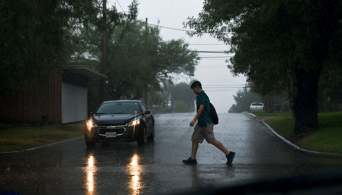 A student walks in the rain after school lets out on Sept. 26, 2017 near N. Jarvis Avenue.