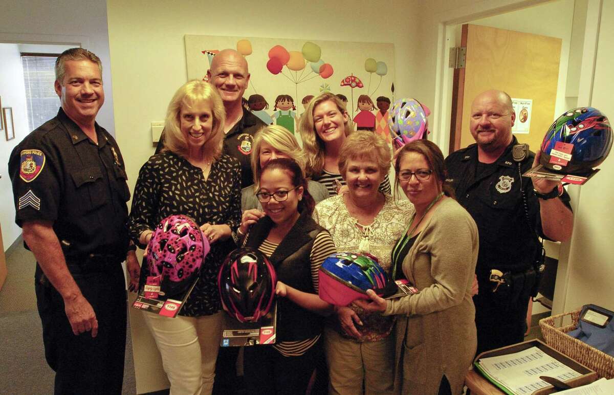 Sgt. Chris Gioielli, Sgt Kris Engstrand and Police Officer John Buehler, all of the Stamford Police Association drop off child bike helmets with representatives of Abilis Therapeutic Services in Stamford, Connecticut on Tuesday, Sept. 27, 2017. The Officers visited several non-profits and day care organizations through out the city, distributing 70 bike helmets that will go to needy families.
