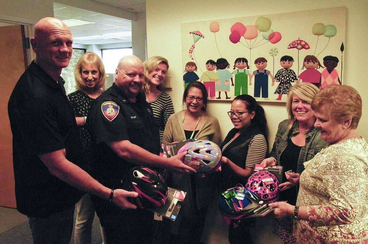 Sgt Kris Engstrand and Police Officer John Buehler, all of the Stamford Police Association drop off child bike helmets with representatives of Abilis Therapeutic Services in Stamford, Connecticut on Tuesday, Sept. 27, 2017. The Officers visited several non-profits and day care organizations through out the city, distributing 70 bike helmets that will go to needy families.