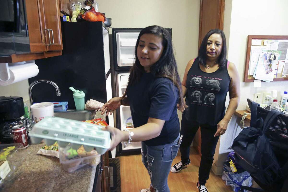 Lori Bailey gets dinner ready with her mother Marta Moody helping as she manages her children, just home from school, at an apartment in Northwest in San Antonio on September 19, 2017.