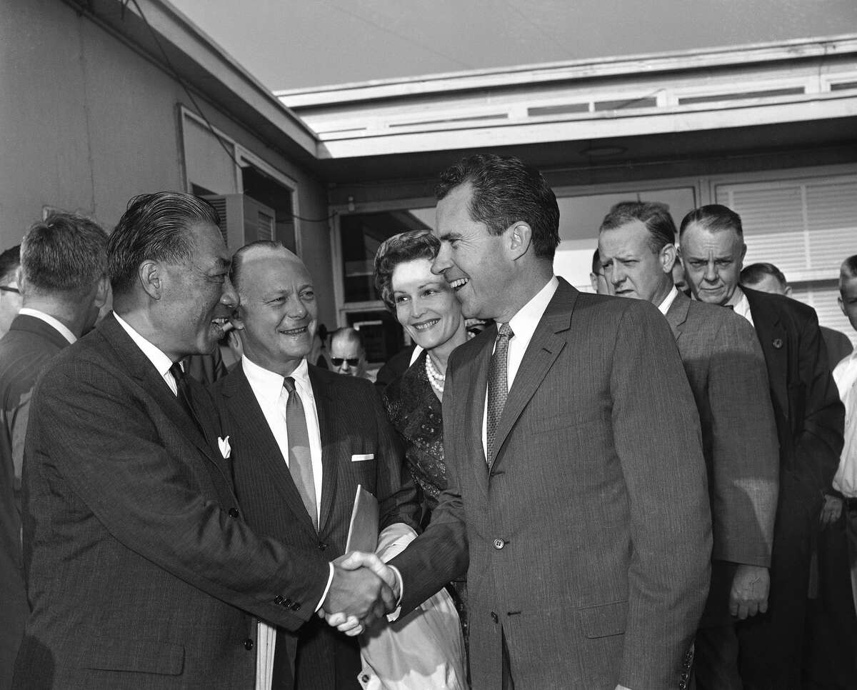 Original caption: Vice President Richard M. Nixon is greeted by Senator Hiram Fong (R-Hawaii) as he arrived at Washington National Airport on August 2, 1960 to take off on his first presidential campaign swing. In center are Secretary of Interior Fred Seaton and Mrs. Nixon. The Senator and the Secretary are accompanying the Nixons on the five day trip which will include stops in Reno, Nev., Los Angeles and Whittier, Calif. Hawaii and Seattle. (AP Photo)