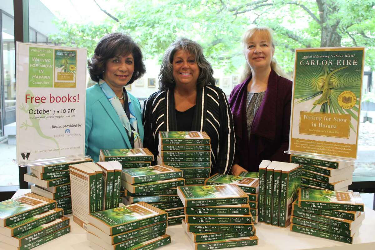 Pictured with copies of “Waiting for Snow in Havana: Confessions of a Cuban Boy” are Wilton Library executive director Elaine Tai-Lauria, Fairfield County Bank vice president and Wilton Library trustee Carol Johnson, and Wilton Library assistant director Lauren McLaughlin.