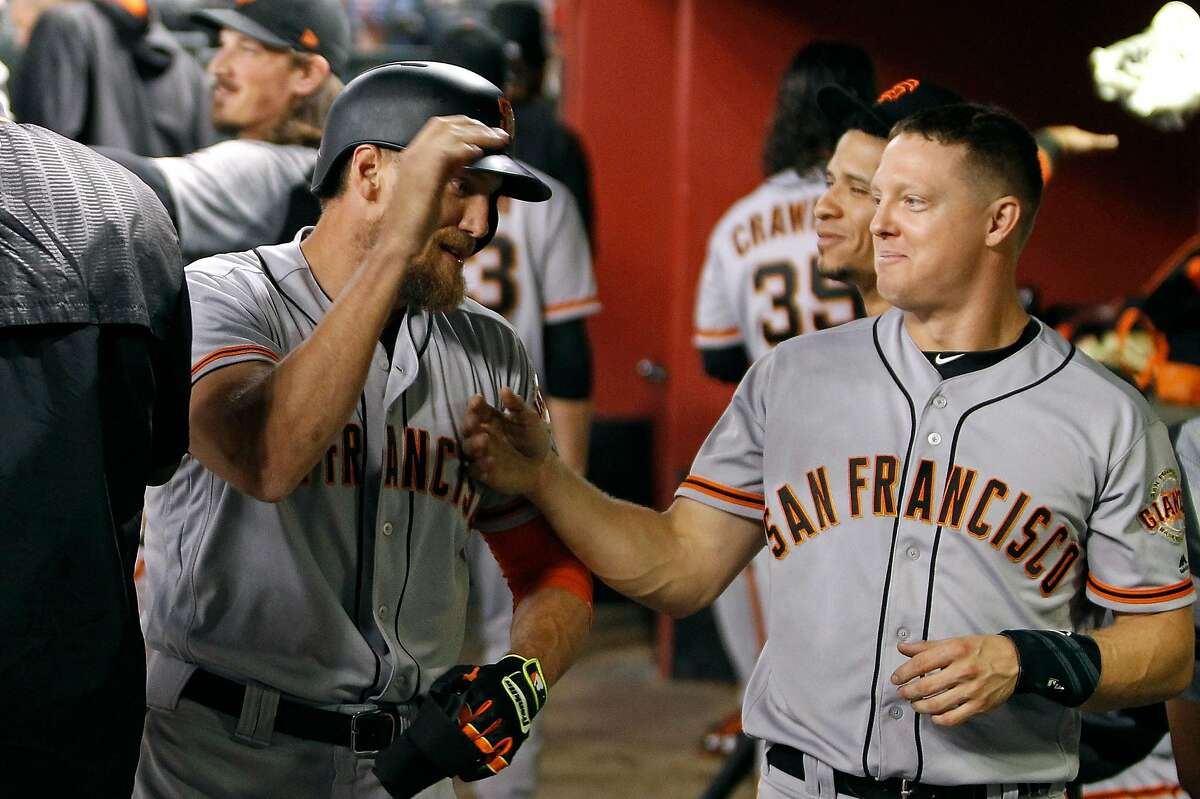 PHOENIX, AZ - SEPTEMBER 25: Hunter Pence #8 of the San Francisco Giants (L) is congratulated by teammate Nick Hundley #5 after hitting a solo home run against the Arizona Diamondbacks during the fourth inning of a MLB game at Chase Field on September 25, 2017 in Phoenix, Arizona. (Photo by Ralph Freso/Getty Images)