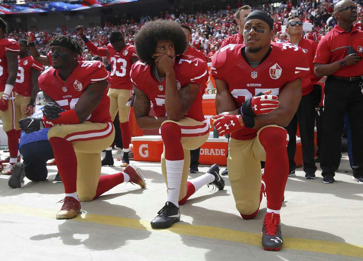 It all started with San Francisco 49er quarterback Colin Kaepernick, center. He is shown kneeling here during the national anthem last year with, from left, teammates Eli Harold and Eric Reid.