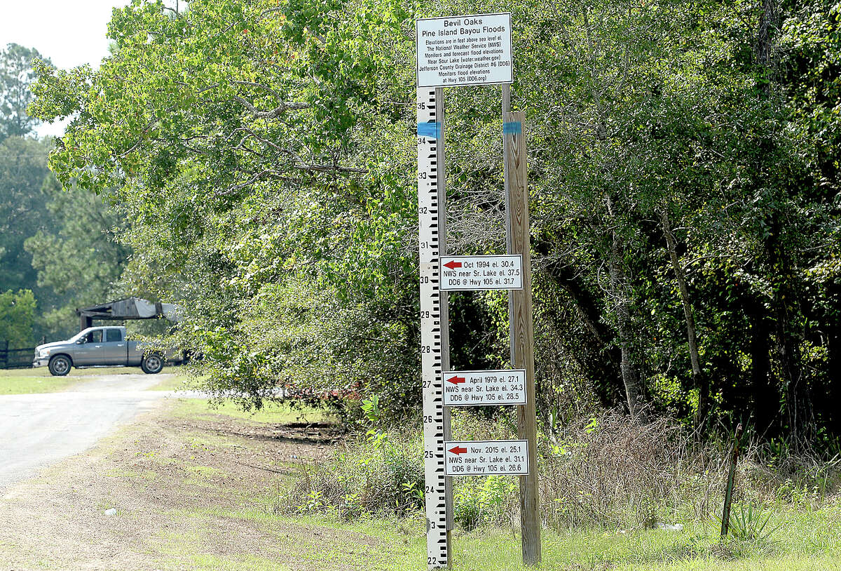 The sign erected previously erected by the city of Bevil Oaks showing historical flood levels in the Pine Island Bayou communities has gotten a new benchmark. A stripe of blue paint shows Harvey's record breaking flood stage at over 34 feet above sea level. Photo taken Thursday, September 28, 2017 Kim Brent/The Enterprise